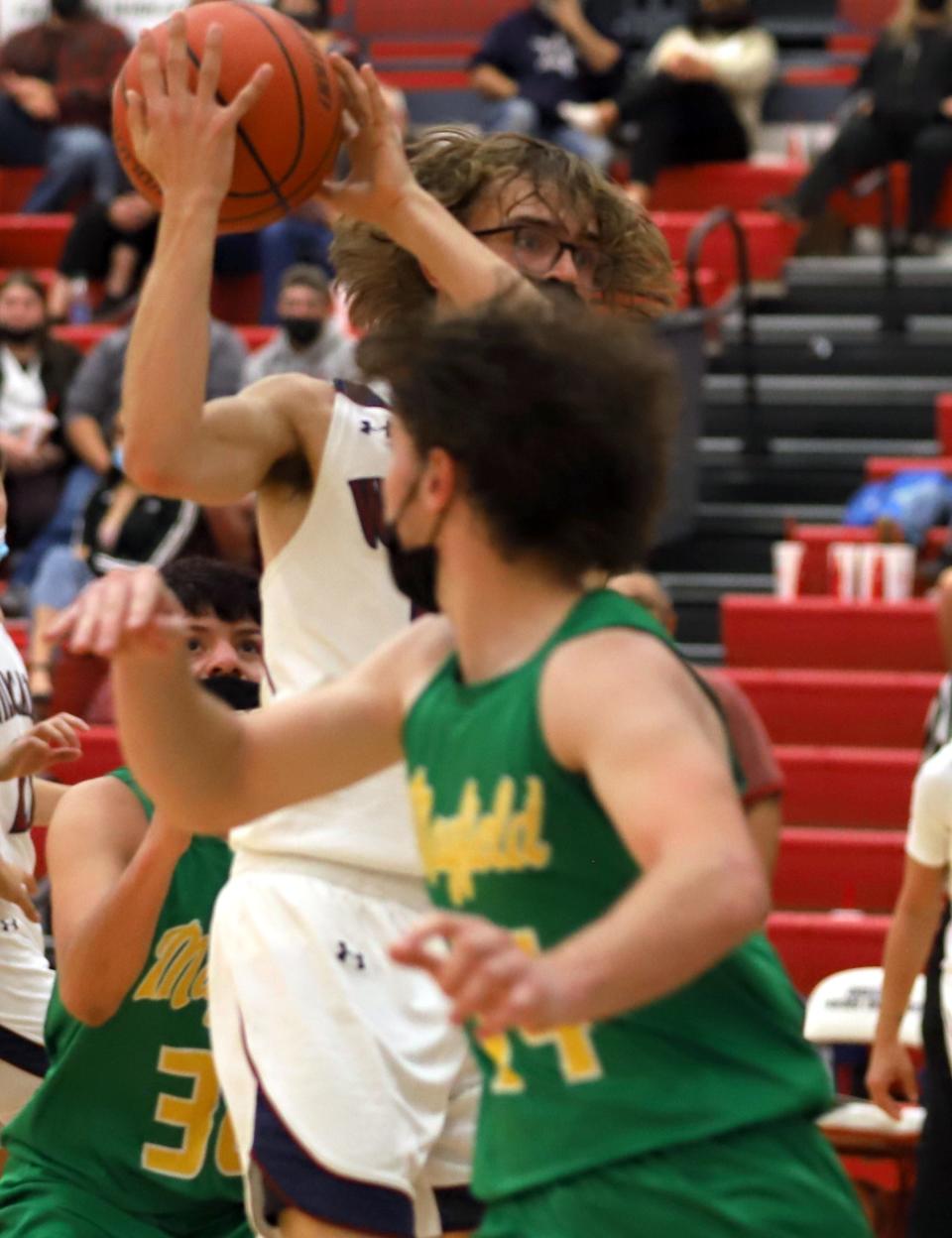 Junior Wildcat Ivan Schultz ((with ball) kept the basketball alive on Deming's side of the court.