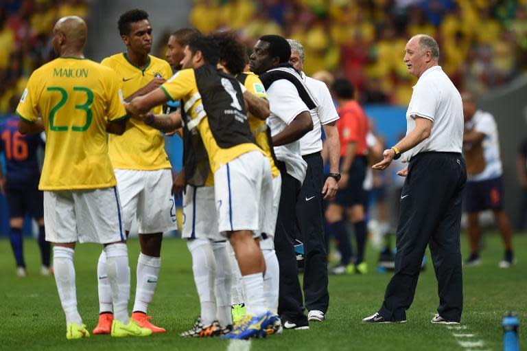 Brazil's coach Luiz Felipe Scolari (R) talks to his players during the third place play-off football match against the Netherlands during the 2014 FIFA World Cup at the National Stadium in Brasilia on July 12, 2014