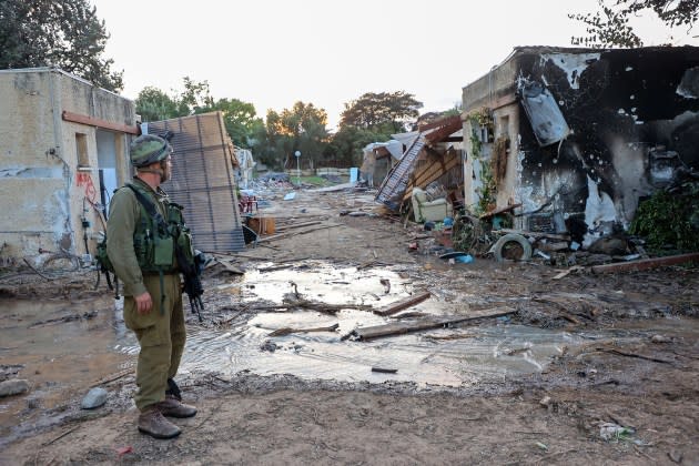 Israeli troops search the scene of a Palestinian militant attack in the Israeli kibbutz of Kfar Aza on the border with the Gaza Strip on October 11, 2023.  - Credit: Gil Cohen-Magen/AFP/Getty Images