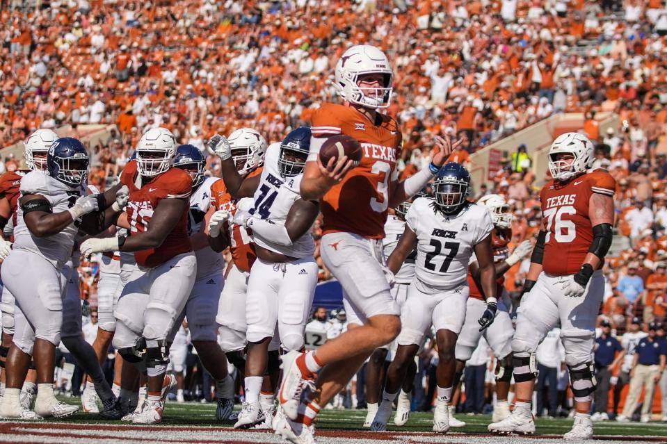 Texas quarterback Quinn Ewers scores on a short run in Saturday's 37-10 win over Rice at Royal-Memorial Stadium. Ewers added 260 yards passing and three touchdowns. The Horns will visit Alabama in Week 2.