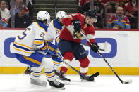 Florida Panthers center Anton Lundell, right, passes the puck as Buffalo Sabres defenseman Owen Power (25) defends during the first period of an NHL hockey game, Saturday, April 13, 2024, in Sunrise, Fla. (AP Photo/Lynne Sladky)