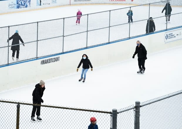 People exercise at an outdoor skating rink during the COVID-19 pandemic in Toronto.