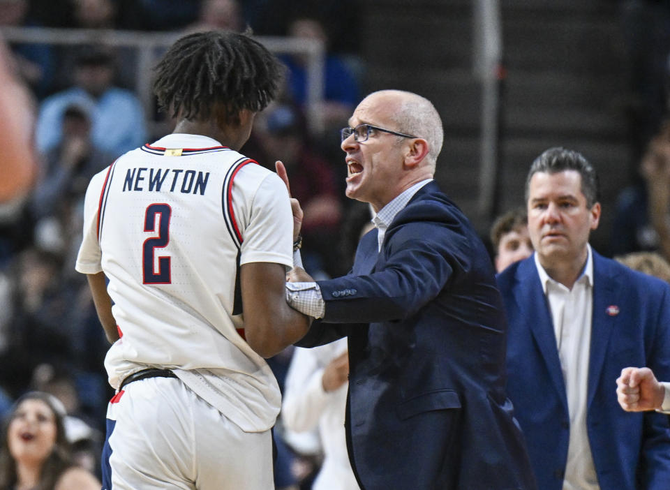 UConn guard Tristen Newton (2) listens to coach Dan Hurley during the first half of the team's second-round college basketball game against Saint Mary's in the men's NCAA Tournament on Sunday, March 19, 2023, in Albany, N.Y. (AP Photo/Hans Pennink)