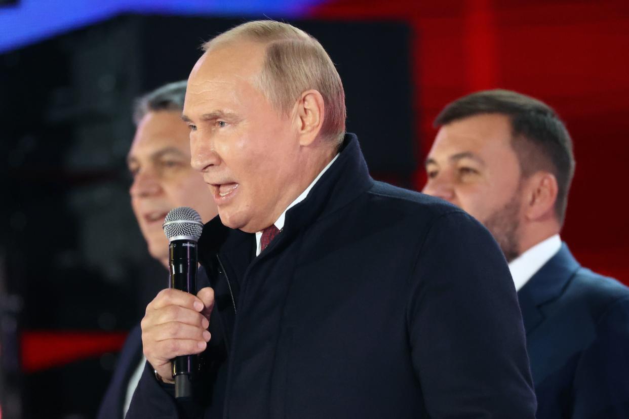 Russian President Vladimir Putin speaks as Leonid Pasechnik, leader of self-proclaimed Luhansk People's Republic, left, and Denis Pushilin, leader of self-proclaimed of the Donetsk People's Republic, right, stand near him during celebrations marking the incorporation of regions of Ukraine to join Russia, Friday, Sept. 30, 2022. 