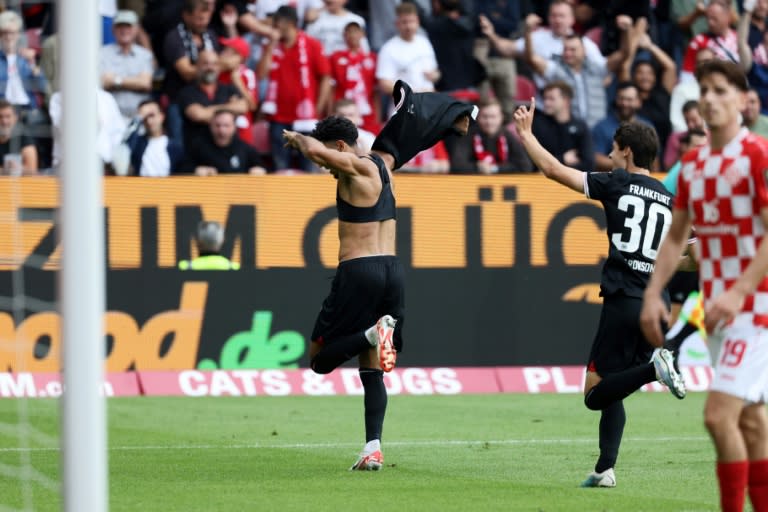 Frankfurt forward Omar Marmoush removes his shirt after scoring a late equaliser away at Mainz (Daniel ROLAND)