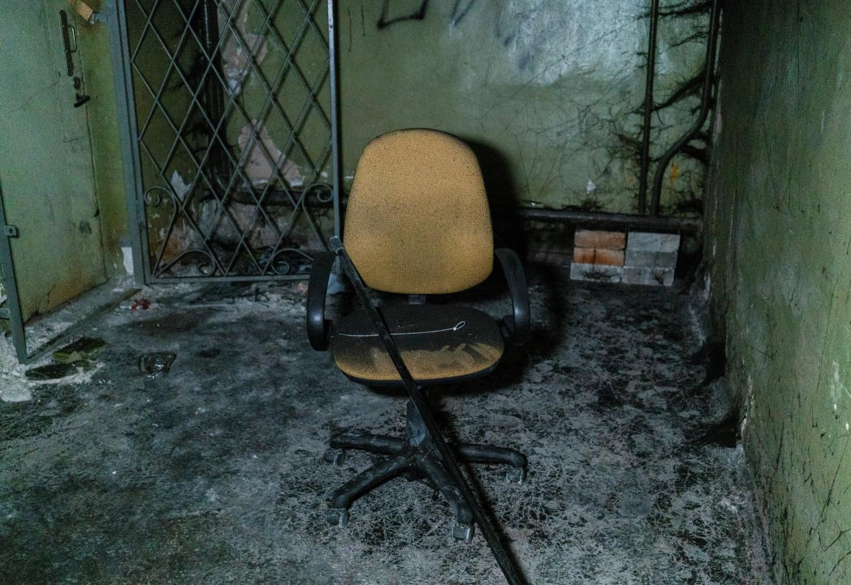 Plastic ties for torture and a broken chair are seen inside a basement of an office building, where prosecutors say 30 people were held two months (REUTERS/Anna Voitenko)