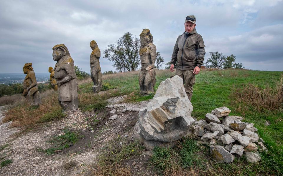 A Ukrainian soldier stands next to the statue's wreckage - JULIAN SIMMONDS 