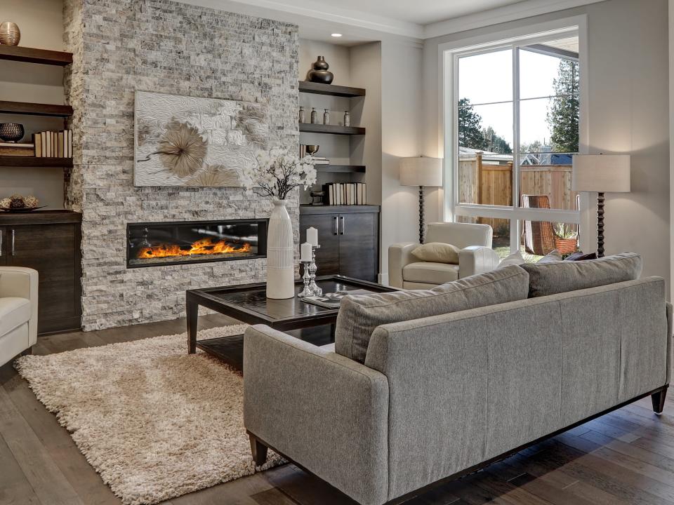 Living room with gray brick fireplace and a gray couch