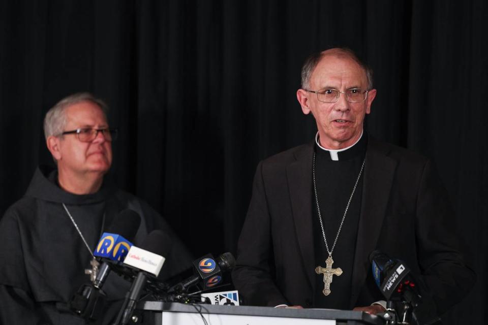 Charlotte Catholic Bishop Peter Jugis, right, announces his retirement after leading the diocese for 20 years, and introduces Franciscan Father Michael T. Martin as his successor during a press conference at the Diocese Pastoral Center in Charlotte, NC on Tuesday, April 9, 2024. Jugis, 67, is retiring due to “health limitations,” according to a diocesan statement. Martin will succeed him as the fifth Bishop of Charlotte.