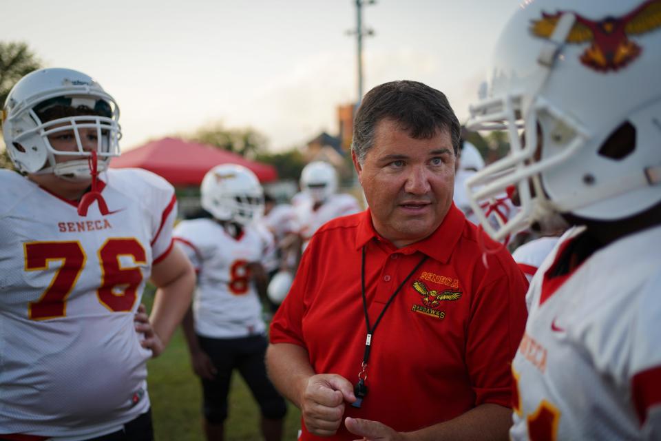 Seneca High School head football coach Keith Eckloff mentors players during the football game played against Shawnee in Louisville, Ky., Saturday, September 6, 2019. 