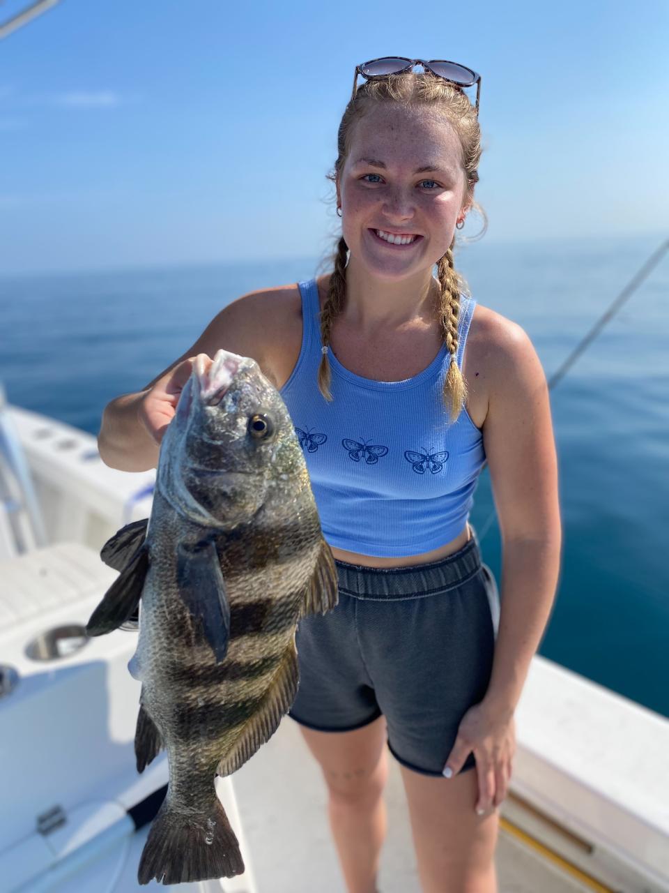 Olivia Shaffer with a black drum she caught  just outside of Ponce Inlet, aboard Capt. Jeff Patterson's Pole Dancer charter boat.