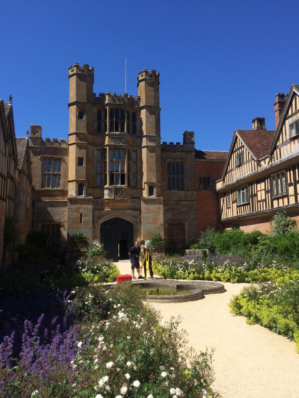 Archaeologist Chris King (left) and mapping specialist Lucasz Bonenberg prepare an exterior laser scan at Coughton Court. <cite>University of Nottingham</cite>