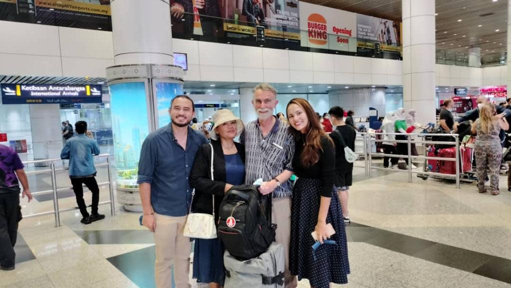 Jim Fitton (second right) with his son Joshua (left), wife Sarijah (second left) and daughter Leila as they were reunited at Kuala Lumpur International Airport on Friday (Family handout/PA).