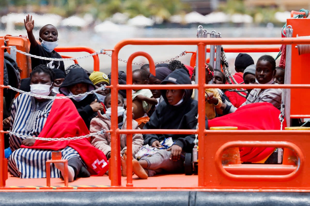 Migrants wait to disembark from a Spanish coast guard vessel in the port of Arguineguin, Gran Canaria, on June 3  (REUTERS)