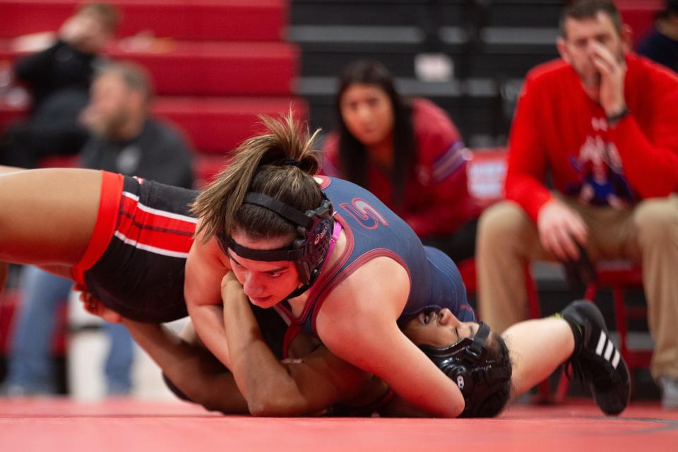 Seaman's Margo Crismas wrestles Lansing's Amari English in the 130 class at the United Kansas Conference Championship Saturday, February 3, 2024, inside Shawnee Heights High School.