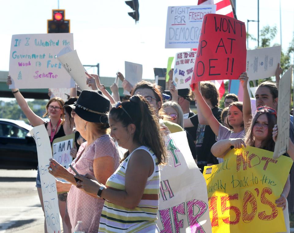 Protesters let their opinions be known during a protest in Plain Township after the U.S. Supreme Court overturned Roe v. Wade on Friday.