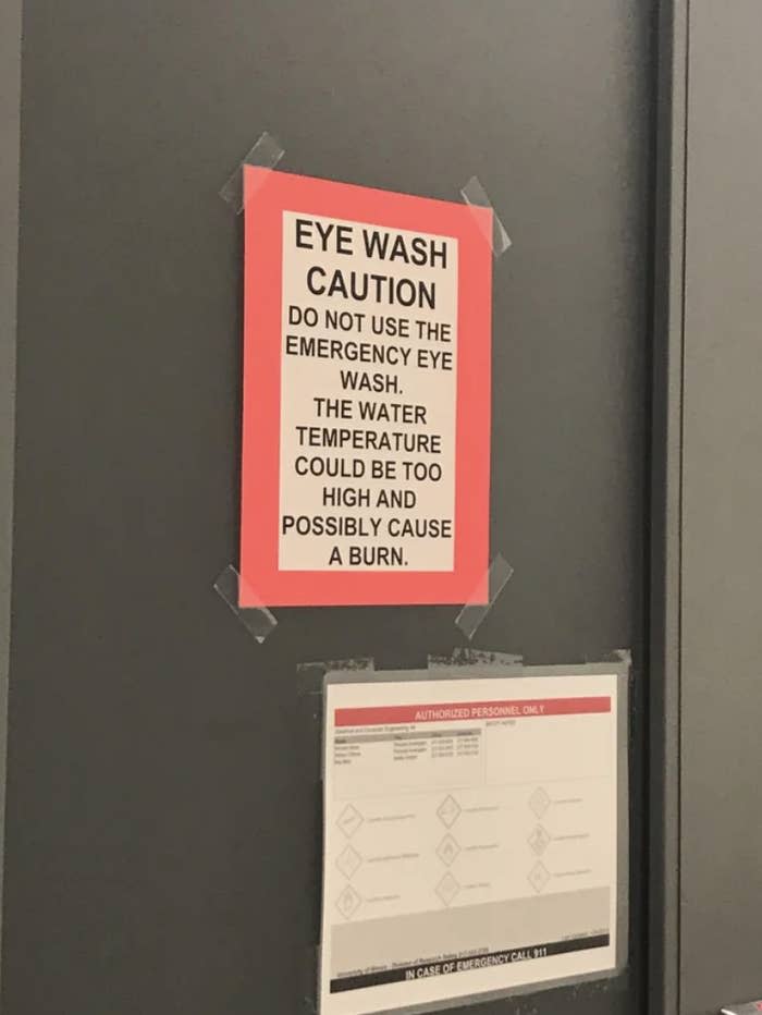 A sign says "do not use the emergency eye wash, the water temperature could be too high and possible cause a burn"