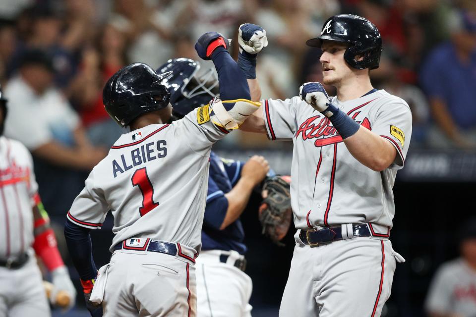 Sean Murphy (right) celebrates with Ozzie Albies after hitting a three-run home run against the Tampa Bay Rays.