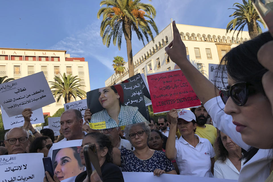 Demonstrators, including prominent activists and journalists, demonstrate in front of Parliament in Rabat, Morocco, Wednesday Oct. 2, 2019. Several dozens of Moroccan activists and journalists protested for the release of jailed journalist Haja Raissouni on Wednesday, warning that the one year prison term handed to her last Monday threatens condition of women and civil rights in the country. (AP Photo/Nadine Achoui-Lesage )