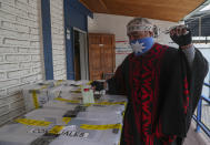 A Mapuche Indigenous man known as Clay casts his ballot at a polling station during the second day of the Constitutional Convention election to select assembly members that will draft a new constitution, in Santiago, Chile, Sunday, May 16, 2021. The face of a new Chile begins taking shape this weekend as the South American country elects 155 people to draft a constitution to replace one that has governed it since being imposed during a military dictatorship. (AP Photo/Esteban Felix)