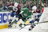 Colorado Avalanche defenseman Devon Toews (7) and defenseman Sean Walker, right, work to keep control of the puck in front of Dallas Stars center Wyatt Johnston (53) during the first period in Game 2 of an NHL hockey Stanley Cup second-round playoff series in Dallas, Thursday, May 9, 2024. (AP Photo/Tony Gutierrez)