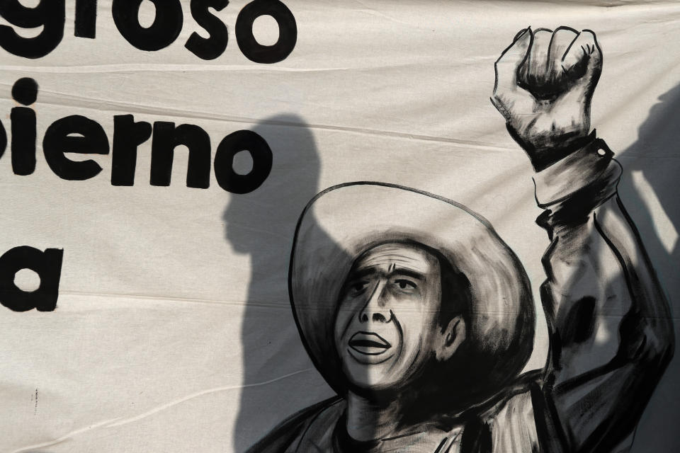 The shadow of a protestor falls on a banner, as students protest outside where President-elect Andres Manuel Lopez Obrador was meeting with parents of college students on the fourth anniversary of the students' disappearance at the hands of police, at the Memory and Tolerance Museum in Mexico City, Wednesday, Sept. 26, 2018. Lopez Obrador said Wednesday his administration will accept a truth commission to investigate the case of 43 teachers-college students missing since Sept. 26, 2014, drawing rare praise and expressions of hope from the long-suffering parents of the victims.(AP Photo/Rebecca Blackwell)