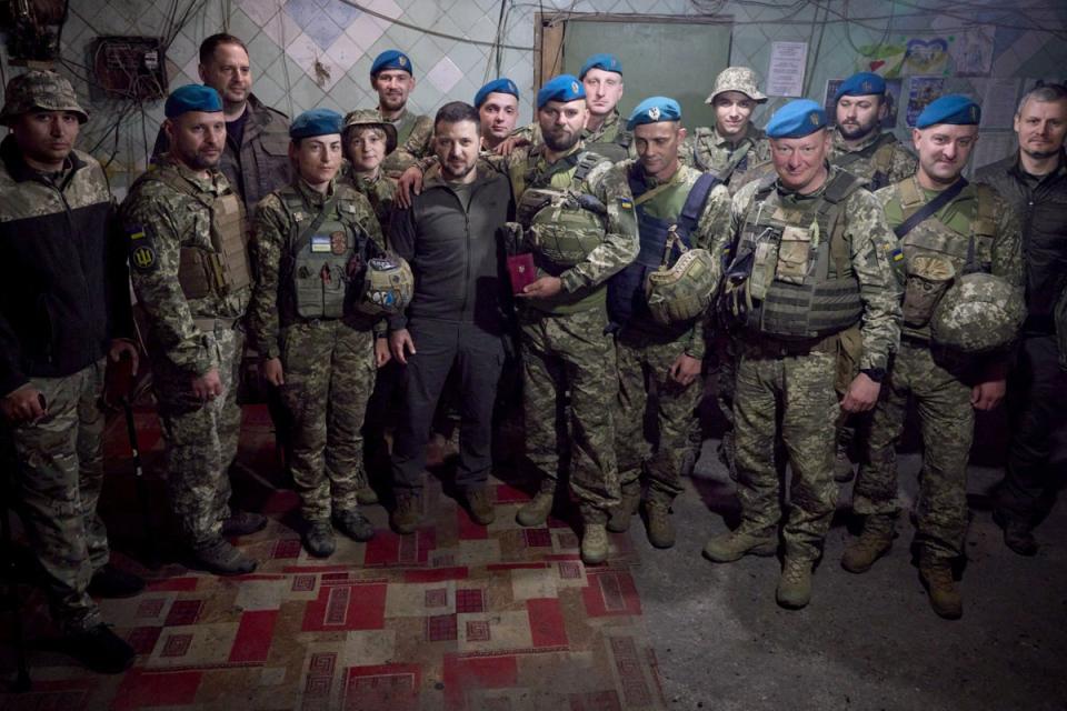 Ukrainian president Volodymyr Zelensky takes a photo with servicemen (AFP via Getty Images)