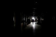 A man walks in a building during power outage in Karachi, Pakistan April 12, 2018. REUTERS/Akhtar Soomro/Files