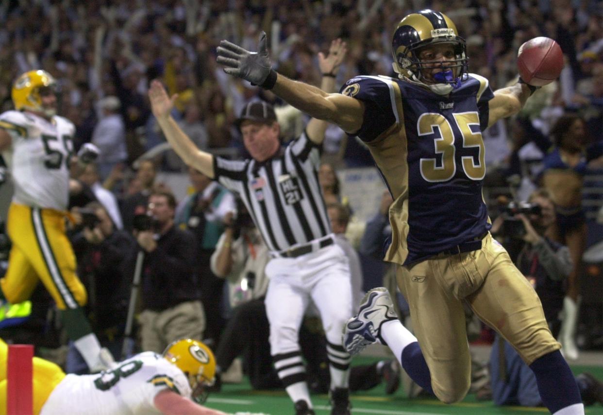 Aeneas Williams celebrates an interception return for a touchdown for the then-St. Louis Rams in 2002.