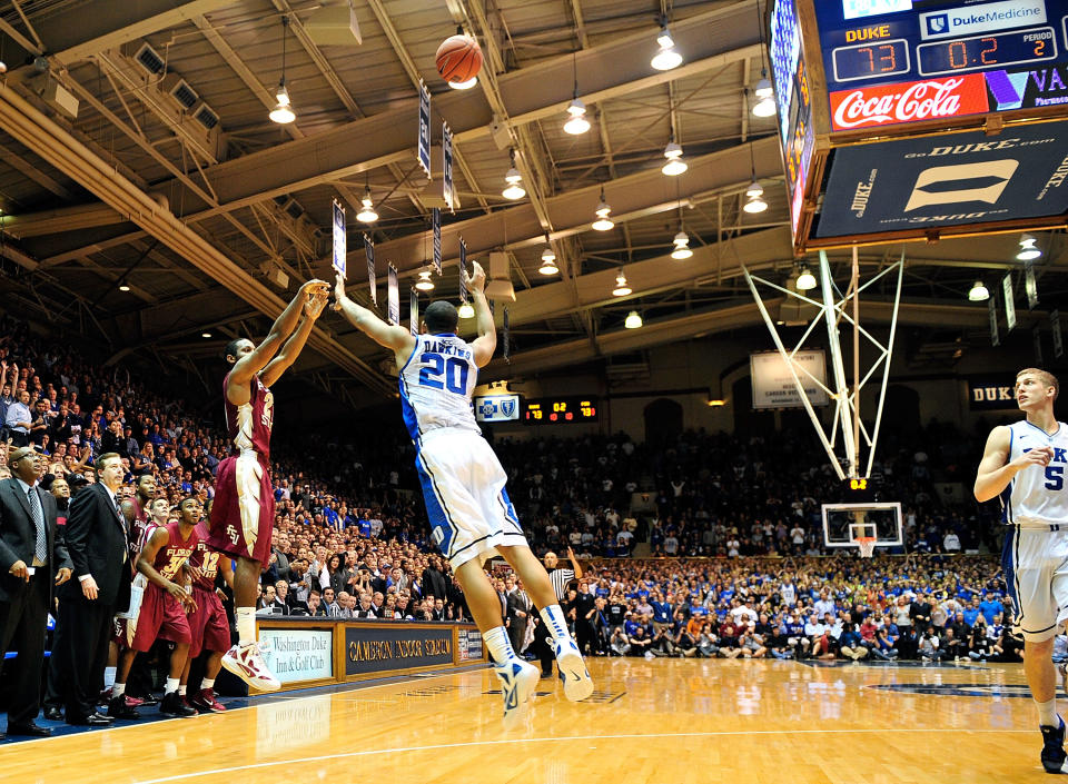 DURHAM, NC - JANUARY 21: Michael Snaer #21 of the Florida State Seminoles scores the game-winning basket over Andre Dawkins #20 of the Duke Blue Devils as time expires at Cameron Indoor Stadium on January 21, 2012 in Durham, North Carolina. Florida State won 76-73 to end Duke's 44-game home winning streak. (Photo by Grant Halverson/Getty Images)