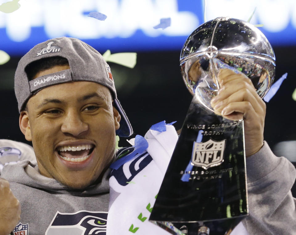 Seattle Seahawks' Malcolm Smith celebrates with the Vince Lombardi Trophy after the NFL Super Bowl XLVIII football game against the Denver Broncos Sunday, Feb. 2, 2014, in East Rutherford, N.J. The Seahawks won 43-8. (AP Photo/Ted S. Warren)
