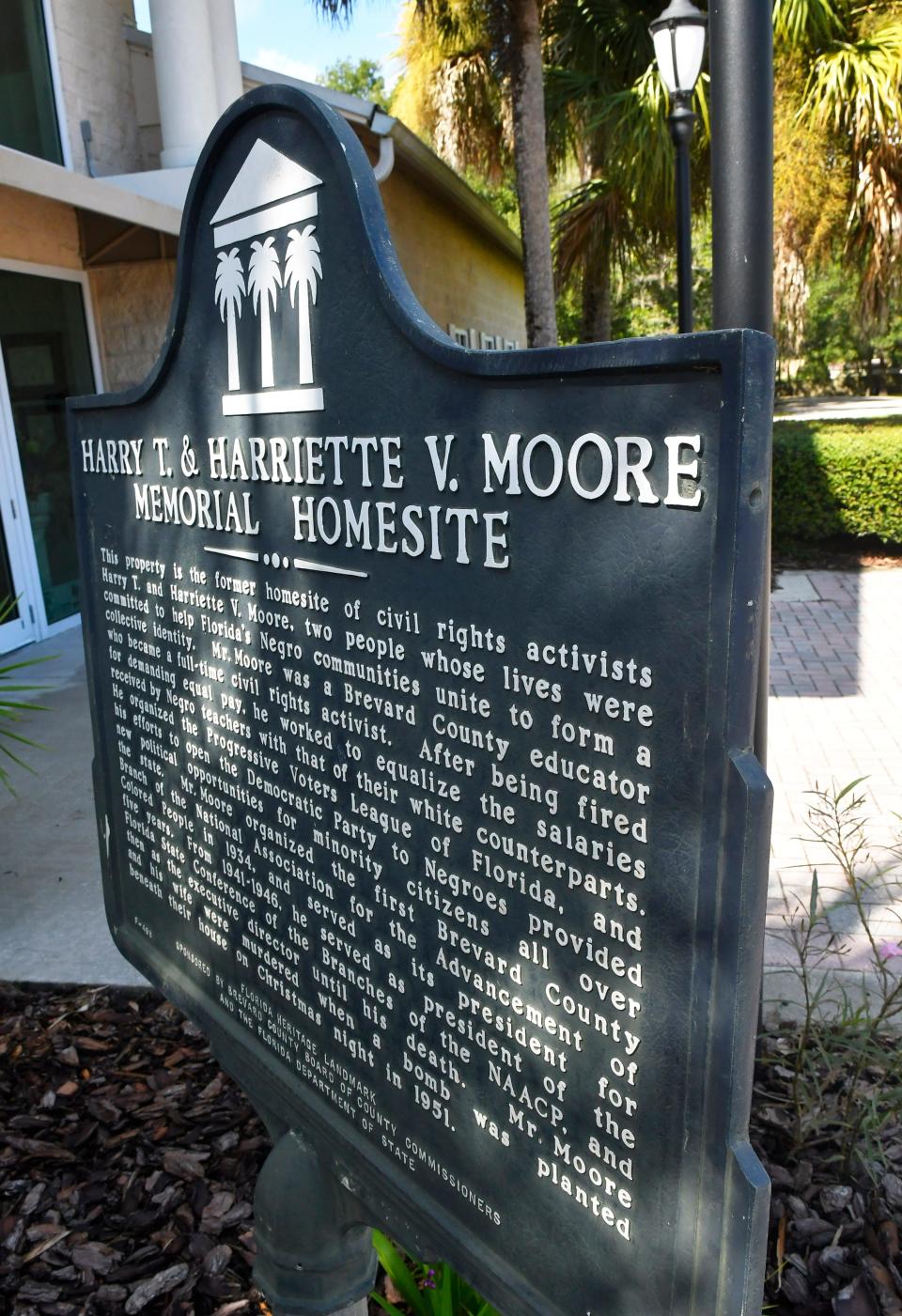 A historic marker details information about Harry T. and Harette V. Moore at the memorial park and museum where the couple lived in Mims.