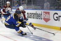 St. Louis Blues' Robert Thomas (18) and Colorado Avalanche's Valeri Nichushkin (13) vie for control of the puck during the second period in Game 3 of an NHL hockey Stanley Cup first-round playoff series Friday, May 21, 2021, in St. Louis. (AP Photo/Scott Kane)