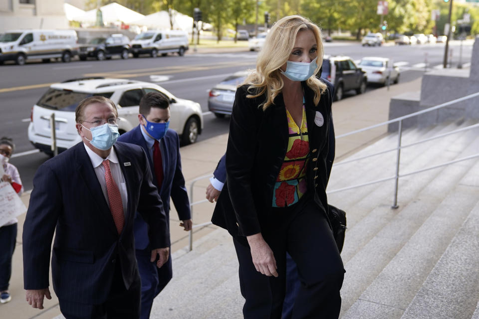 Patricia McCloskey and her husband Mark McCloskey, left, arrive for a court hearing Wednesday, Oct. 14, 2020, in St. Louis. The McCloskeys have pleaded not guilty to two felony charges, unlawful use of a weapon and tampering with evidence, after been seen waving guns at protesters marching on their private street this past summer. (AP Photo/Jeff Roberson)