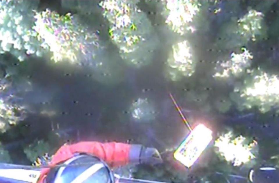 A rescue worker hoists Sajean Geer to safety (US Coast Guard)