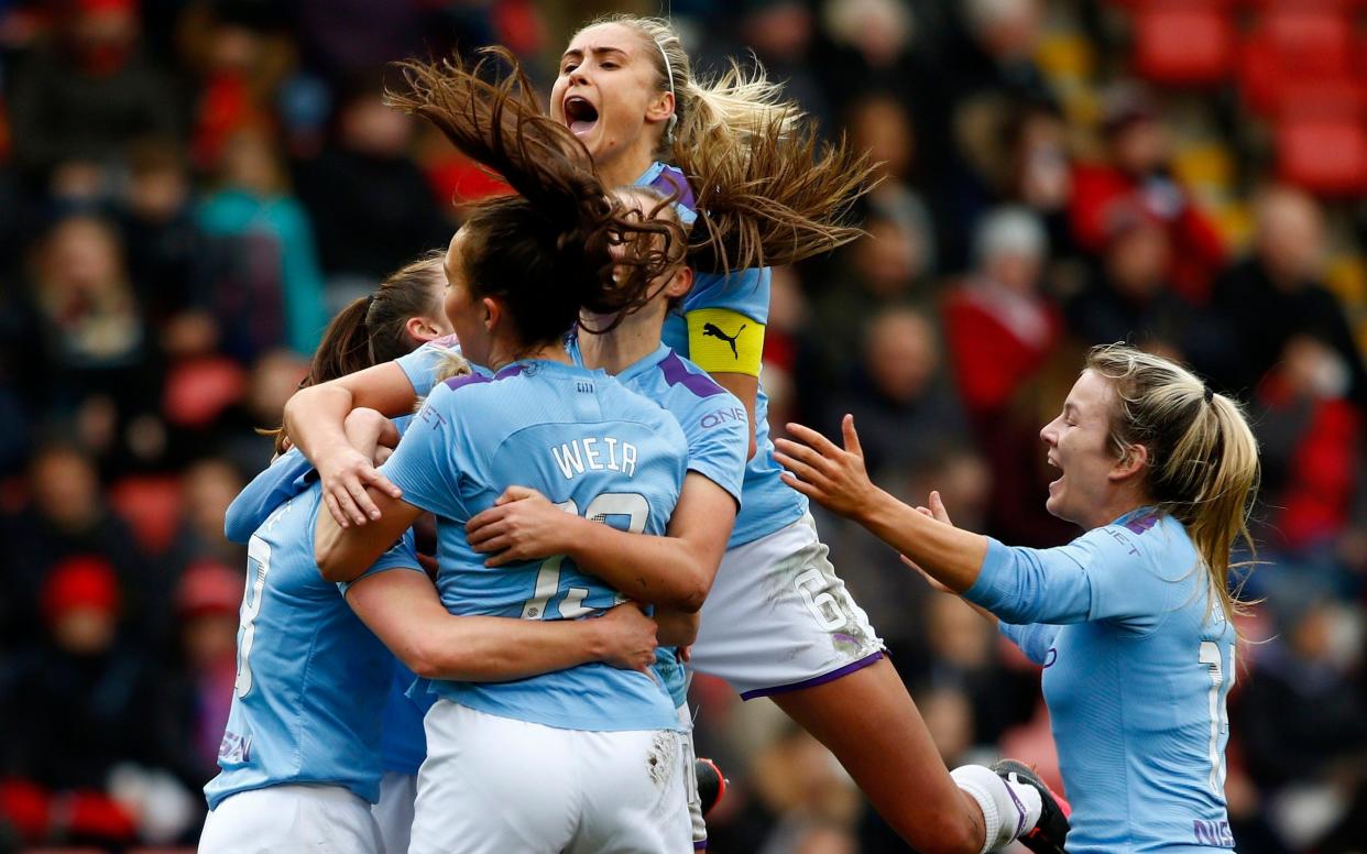 Jill Scott of Manchester City (obscured) celebrates with teammates after scoring her team's third goal during the Women's FA Cup Fourth Round match between Manchester United Women and Manchester City Women  - Morgan Harlow/Getty Image