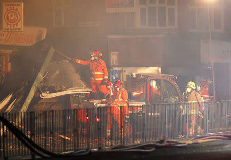 Members of the emergency services work at the site of an explosion which destroyed a convenience store and a home in Leicester, Britain, February 25, 2018. REUTERS/Darren Staples