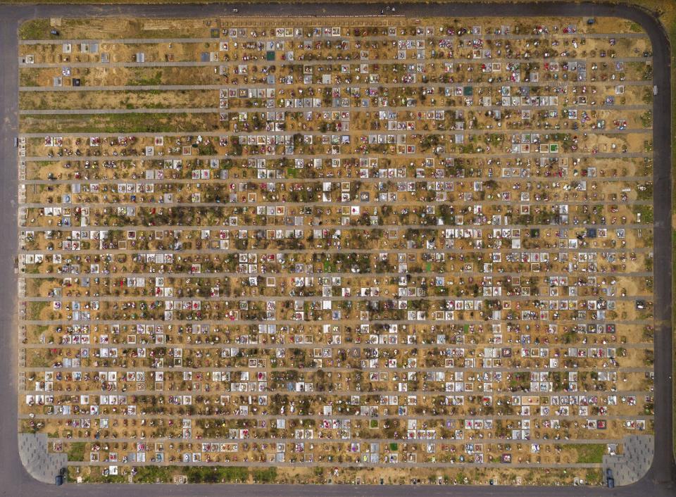 An aerial view shows fresh graves at the Yastrebkovskoe cemetery, which serves as one of the burial grounds for those who died of the coronavirus, outside in Moscow, Russia, Thursday, Oct. 21, 2021. The government coronavirus task force reported 36,339 new confirmed infections and more than thousand deaths in the past 24 hours. That brought Russia's death toll to 227,389, by far the highest in Europe. Moscow Mayor Sergei said all restaurants, cafes and non-food stores, gyms, cinemas and other entertainment venues in the Russian capital will be shut from Oct. 28 to Nov. 7. (AP Photo/Dmitry Serebryakov)