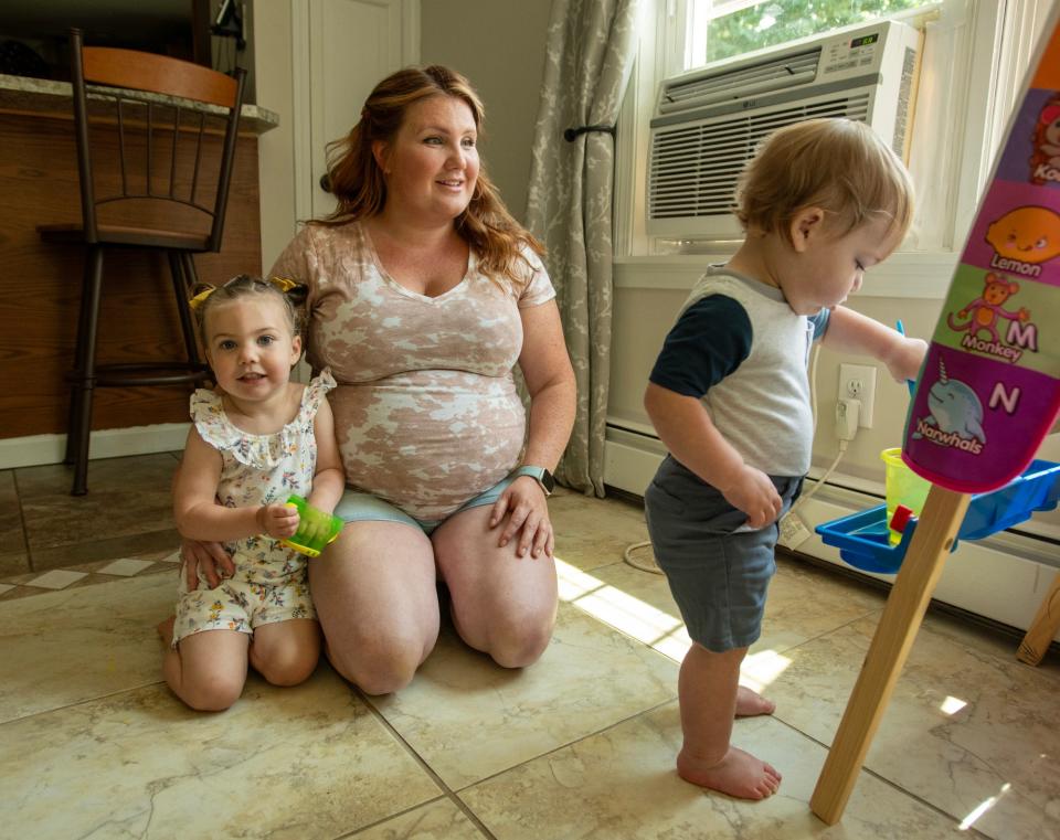 Expectant mother Lauren Colameta and her children Cecilia and Walter play Wednesday in their Templeton home.