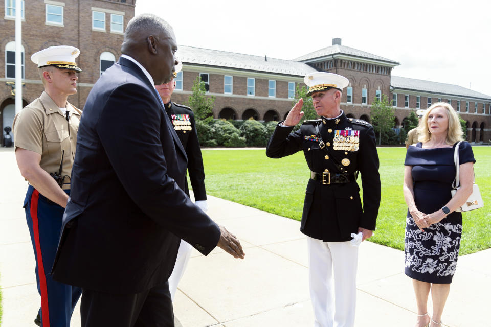 U.S. Marine Corps Acting Commandant Gen. Eric Smith, second from right, salutes Defense Secretary Lloyd Austin, second from left, during a relinquishment of office ceremony for U.S. Marine Corps Gen. David Berger, Monday, July 10, 2023, at the Marine Barracks in Washington. Smith, currently the assistant commandant, has been nominated to be the next leader, but will serve in an acting capacity because he hasn't been confirmed by the Senate. (AP Photo/Manuel Balce Ceneta)