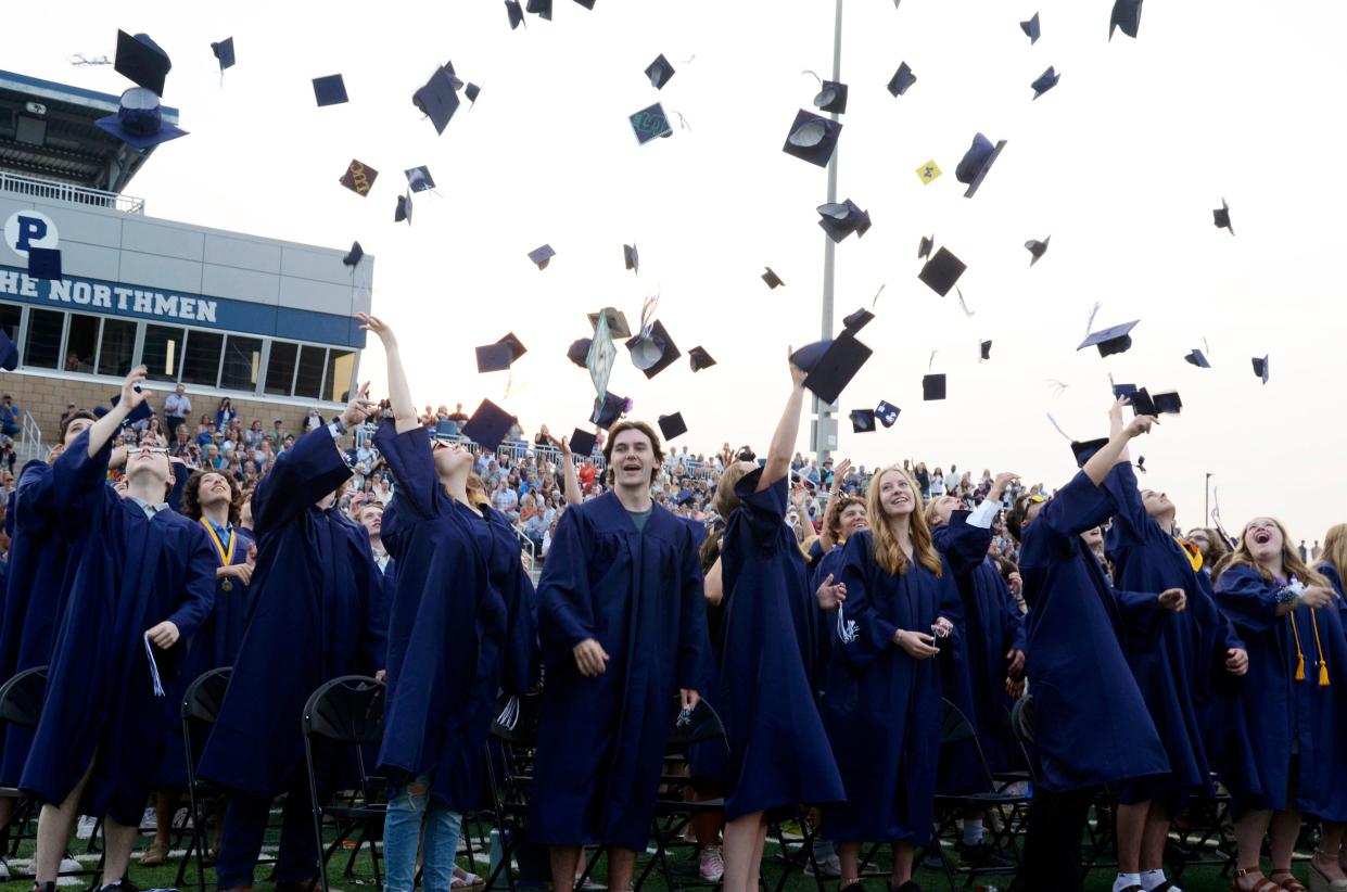 The Petoskey High School Class of 2023 toss their caps in the air during their commencement ceremony.