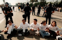 FILE - In this Oct. 23, 1996, file photo, UCLA students, surrounded by Los Angeles police officers, sit on Wilshire Boulevard during an anti-Proposition 209 protest in front of the Federal Building in the Westwood section of Los Angeles. In November 2020, a California with vastly different political preferences and demographics will consider repealing a 1996 law barring state and local governments from discriminating against or granting preferential treatment to people based on race, ethnicity, national origin or sex. If approved, Proposition 16 would repeal a 1996 initiative that made it unlawful for state and local governments to discriminate against or grant preferential treatment to people based on race, ethnicity, national origin or sex. (AP Photo/Frank Wiese, File)