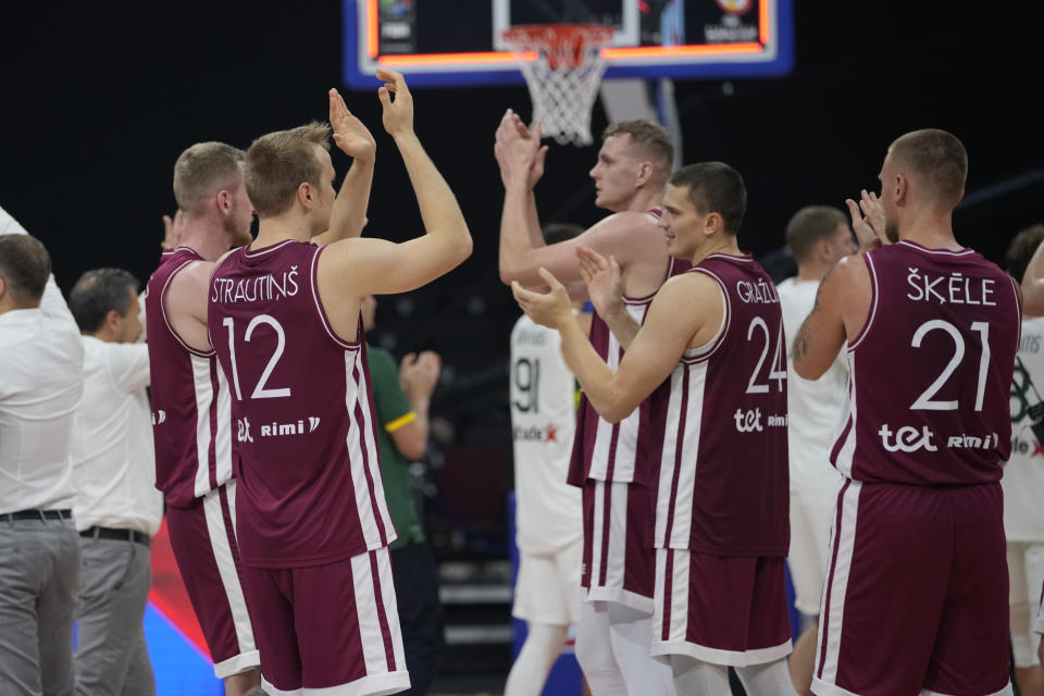 Latvia team celebrates after winning against Lithuania during the Basketball World Cup classification match in Manila, Philippines, Saturday, Sept. 9, 2023. (AP Photo/Aaron Favila)