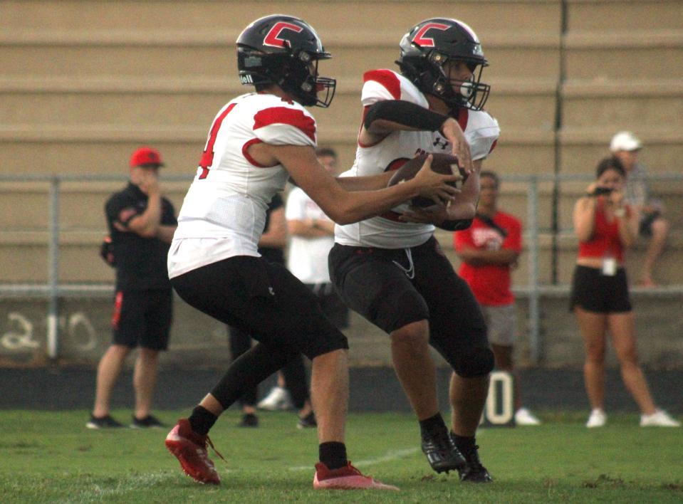 Creekside quarterback Wilson Edwards (4) fakes a handoff to running back Nicky Williams (28) during  a high school football preseason game against Fletcher on August 19, 2022. [Clayton Freeman/Florida Times-Union]