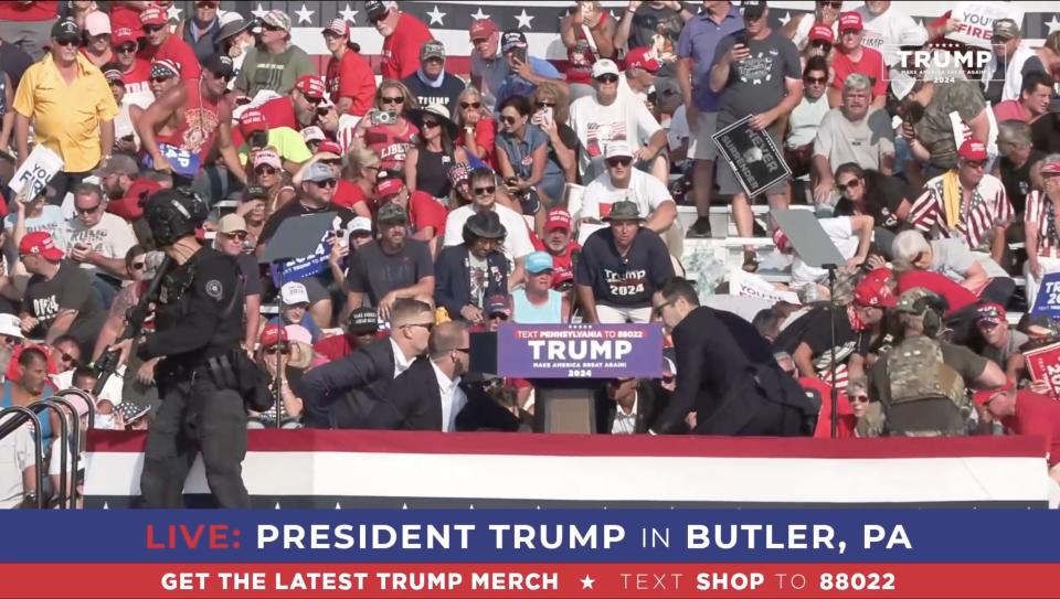 BUTLER, PENNSYLVANIA, UNITED STATES - JULY 13: (----EDITORIAL USE ONLY - MANDATORY CREDIT - 'TRUMP CAMPAIGN OFFICE / HANDOUT' - NO MARKETING NO ADVERTISING CAMPAIGNS - DISTRIBUTED AS A SERVICE TO CLIENTS----) A screen grab captured from a video shows Republican presidential candidate former President Donald Trump appears to be injured after gunshots were reported as he is rushed offstage during a rally on July 13, 2024 in Butler, Pennsylvania. Trump was seen bloodied on his right ear as he was being evacuated from the stage, according to social media footage. (Photo by Trump Campaign Office / Handout/Anadolu via Getty Images)