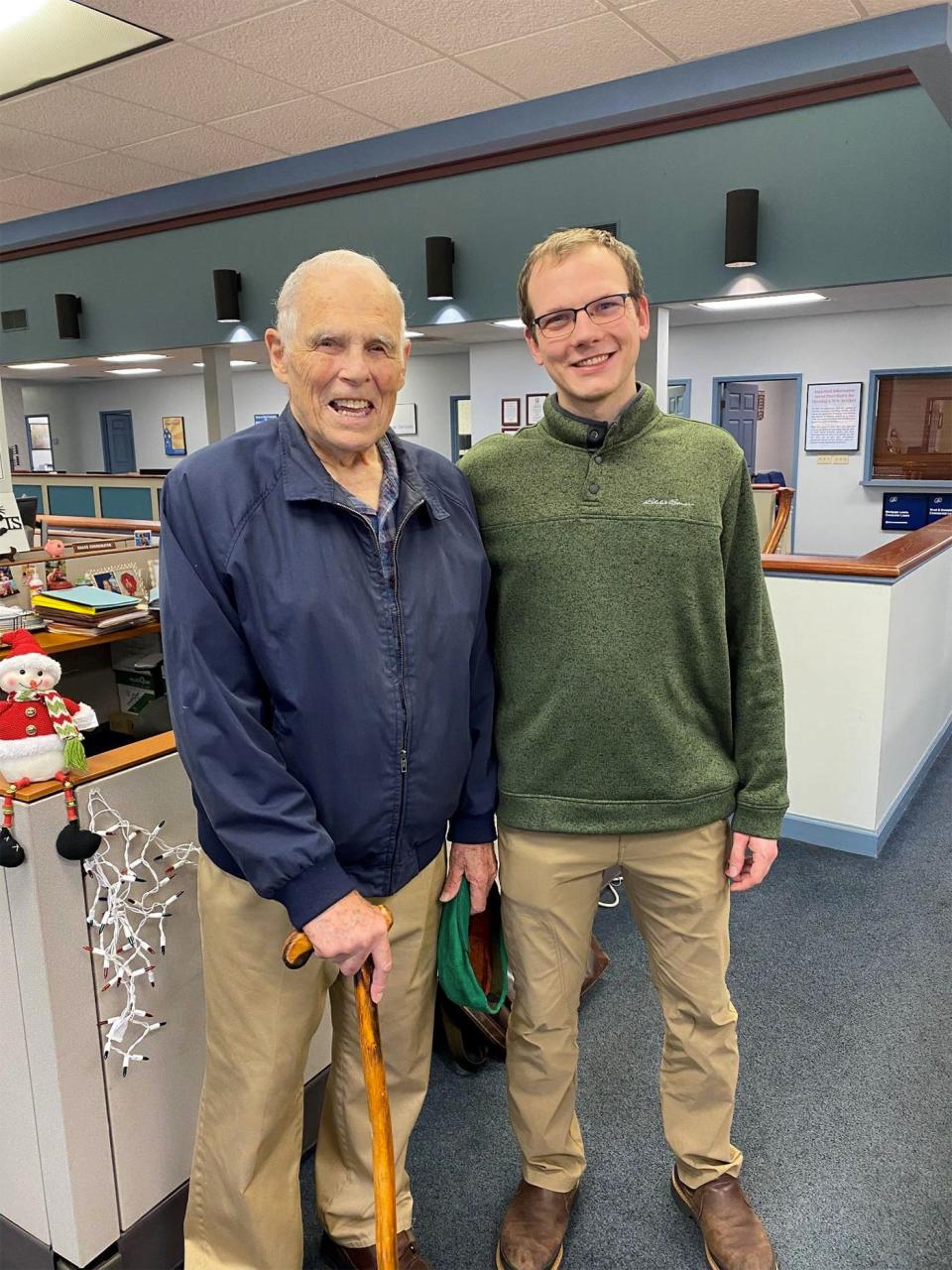 Bud Vear, left, and Bryce Asberg at County National Bank after they paid off the mortgage for Helping Hands PRC.