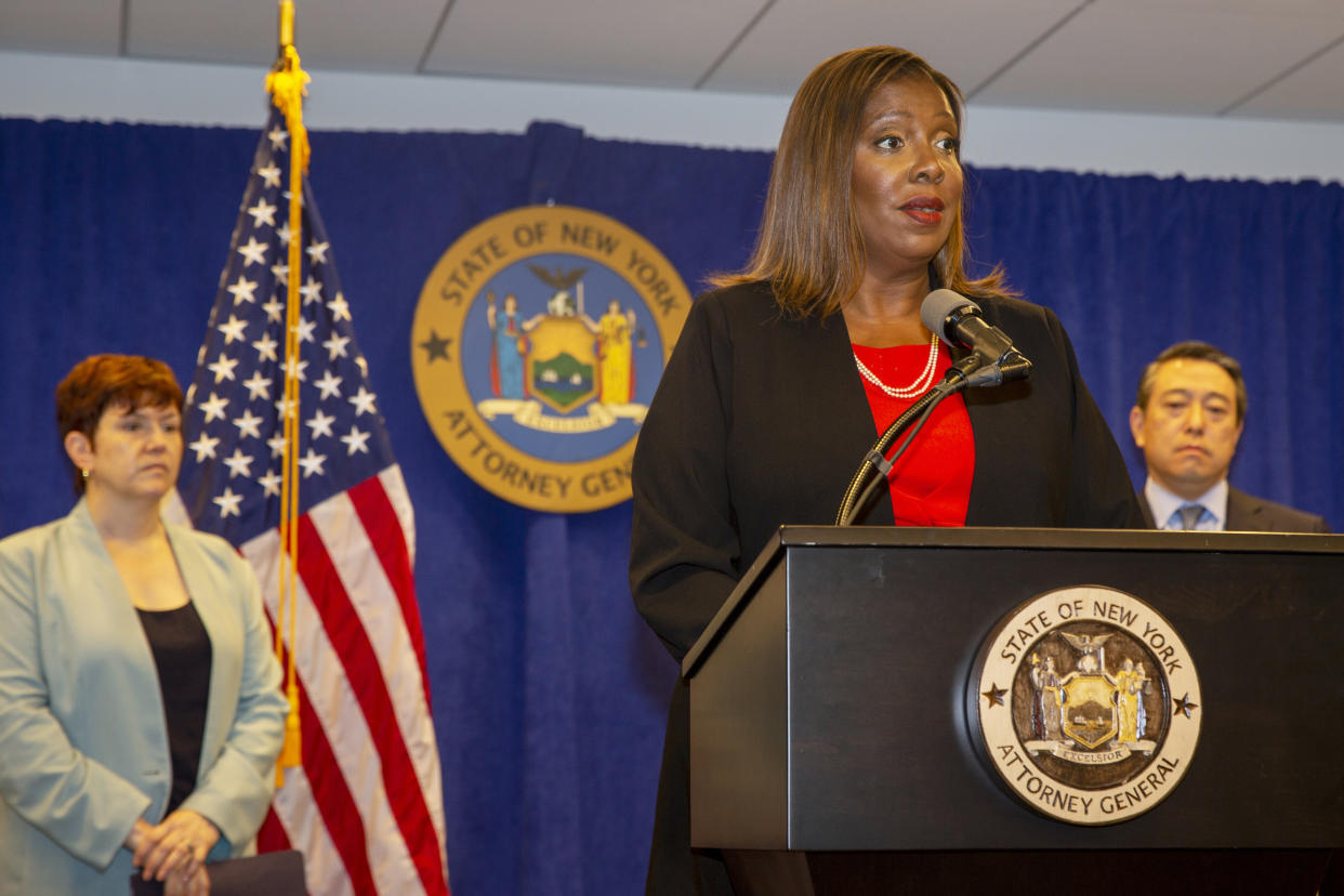 New York State Attorney General Letitia James speaks at a press conference, Tuesday, Aug. 3, 2021,  in New York. An investigation found that New York Gov. Andrew Cuomo sexually harassed multiple women in and out of state government and worked to retaliate against one of his accusers, James announced Tuesday. Attorneys Joon Kim, right, and Anne L. Clark, lead investigators, listen.  (AP Photo/Ted Shaffrey)