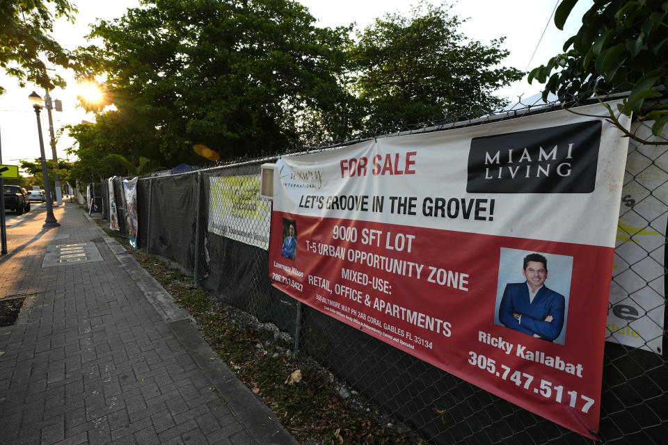 A sign advertises a vacant lot for sale in the Miami neighborhood of west Coconut Grove, Friday, April 5, 2024. The majority-Black neighborhood — known by names such as West Grove, Black Grove, or even Little Bahamas, in a nod to its Bahamian roots — has nurtured the early careers of numerous notable sports figures, from Olympic Gold medalists to NFL Hall of Famers like Frank Gore and Amari Cooper, as well as housed successful Black business owners and stalwarts who played a vital role in city's history and culture. (AP Photo/Lynne Sladky)