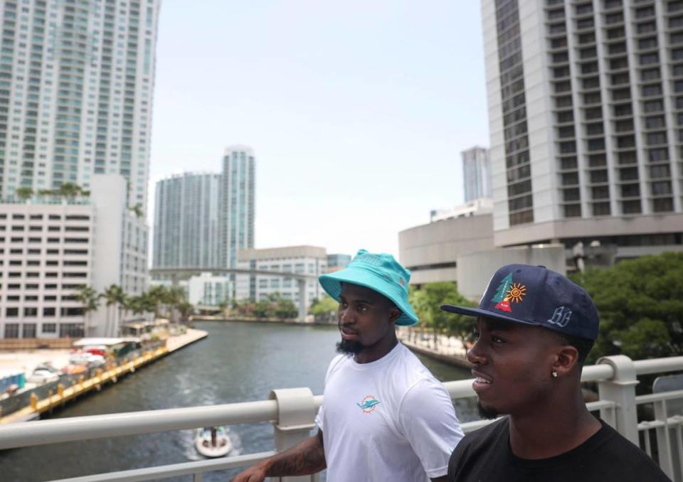 ZaQuandre White, left, running back in the Miami Dolphins rookie class, and Kader Kohou, defensive back, participate in a historic walking tour of Downtown Miami with local community groups on Wednesday, June 15, 2022 beginning with tour leaders at the History Miami Museum.