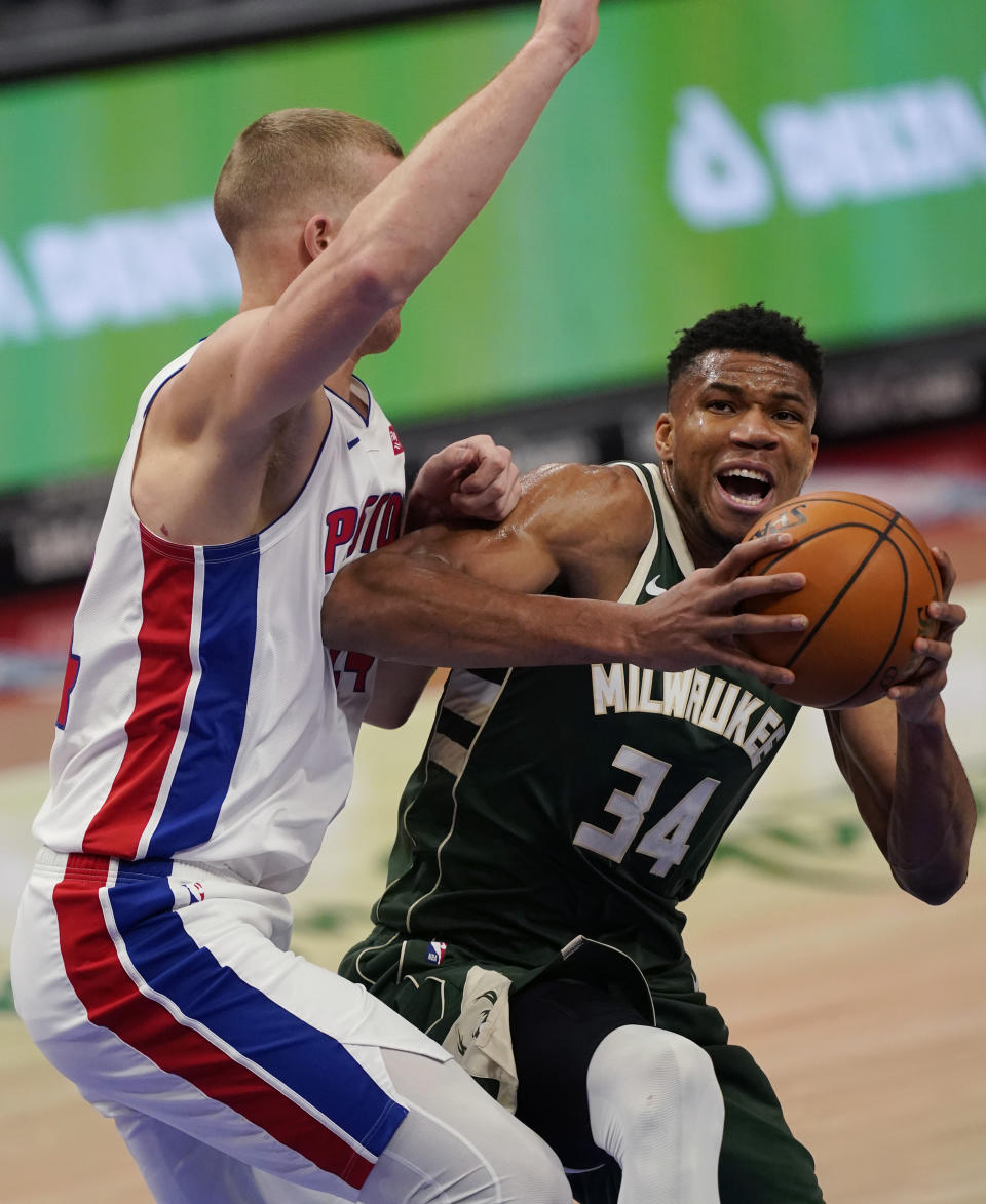 Milwaukee Bucks forward Giannis Antetokounmpo (34) is defended by Detroit Pistons center Mason Plumlee during the first half of an NBA basketball game, Wednesday, Jan. 13, 2021, in Detroit. (AP Photo/Carlos Osorio)
